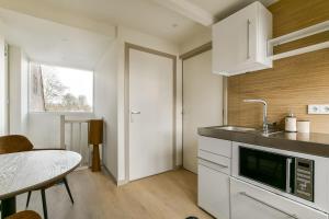 a kitchen with a sink and a counter top at The Rietvink Residence in Wervershoof +15 photos