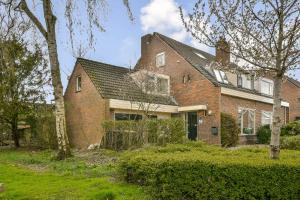 a large brick house with a roof at The Rietvink Residence in Wervershoof