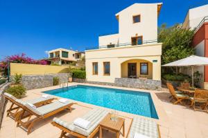 a villa with a swimming pool and a house at Villa Aphrodite in Plaka
