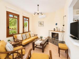 a living room with a couch and a fireplace at Villa Aphrodite in Plaka