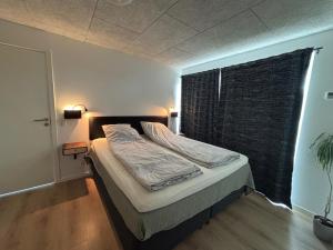 a bed in a room with a window and a bed sidx sidx sidx at New apartment, only 4 km from the highway in Horsens