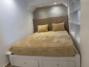 a bedroom with a bed with a headboard and white cabinets at Sidi studio 8bis in Sidi Bou Saïd