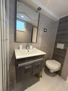 a bathroom with a sink and a toilet and a mirror at Sidi studio 8bis in Sidi Bou Saïd +23 photos