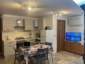 a kitchen with a table with two laptops on it at Logudoro Cabin by Holiday World in Alghero