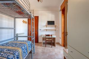 a bedroom with a bunk bed and a desk at Casa Lucia a Torre Lapillo in Torre Lapillo
