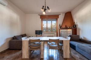 a living room with a table and chairs and a couch at Casa Lucia a Torre Lapillo in Torre Lapillo +15 photos