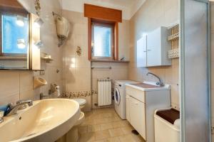 a bathroom with a sink and a washing machine at Casa Lucia a Torre Lapillo in Torre Lapillo