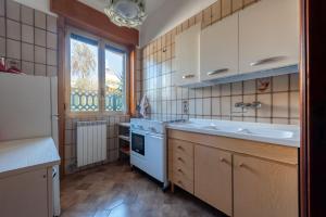 a small kitchen with a sink and a stove at Casa Lucia a Torre Lapillo in Torre Lapillo