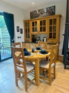 a wooden table and chairs in a kitchen at Hawks Hideaway in Warminster +14 photos