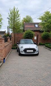 a white car parked in front of a house at Hawks Hideaway in Warminster