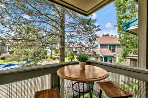 a balcony with a table and two chairs at Lakeland Village #476 in South Lake Tahoe