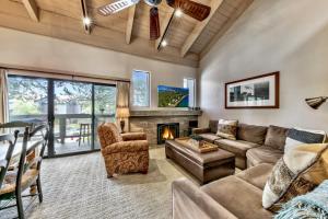 a living room with a couch and a fireplace at Lakeland Village #476 in South Lake Tahoe