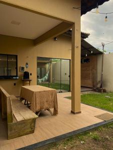 a wooden deck with a table and a bench at Good Winds Kite House in Cruz