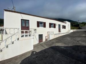 a white building with stairs and windows on it at Ron House in São Caetano