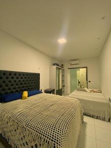 a bedroom with two beds and a mirror at Good Winds Kite House in Cruz