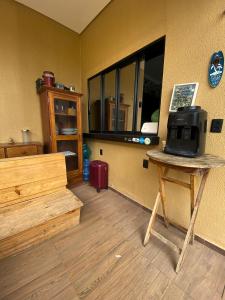 a room with a room with a table and a window at Good Winds Kite House in Cruz