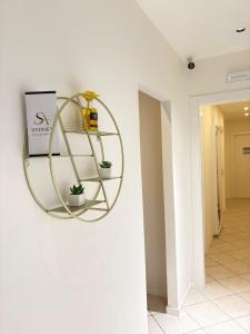 a round shelf on a wall in a hallway at Sydney Apartment in Frosinone
