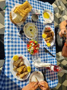 a blue and white table with plates of food on it at villa stavri in Pogradec