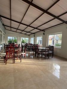 a dining room with wooden tables and chairs at Cửu Long Beach Phú Quốc in Phú Quốc