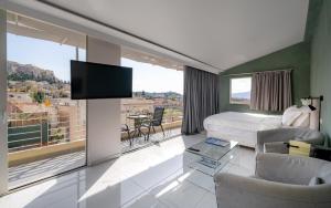 a hotel room with a bed and a large window at 24K Athena Suites in Athens