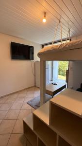 a living room with a flat screen tv on a wall at Peace's House, Studio moderne, Bas-du-Fort, Plage à pied, Parking privé in Le Gosier