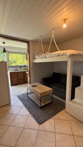 a room with a bunk bed and a coffee table at Peace's House, Studio moderne, Bas-du-Fort, Plage à pied, Parking privé in Le Gosier