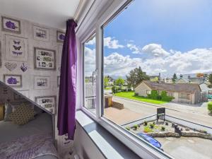 a bedroom with a window with a view of a street at Dunroamin Bed and Breakfast in Aviemore
