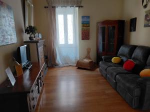 a living room with a couch and a television at Berny House in Bracciano