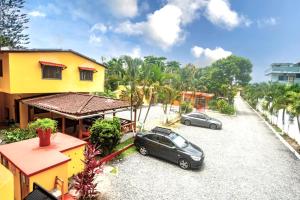 two cars parked in the driveway of a house at Hotel Cielo Azul in Atacames