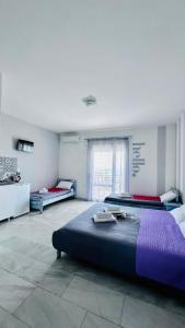 a large bedroom with two beds and a window at Doma by Kristina in Chrysi Ammoudia