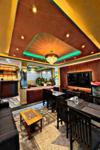 a restaurant with a bar with tables and chairs at CG Hotel in Kathmandu