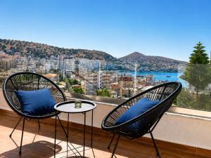 two chairs and a table on a balcony with a view at Villa Saral Mar in Sarandë