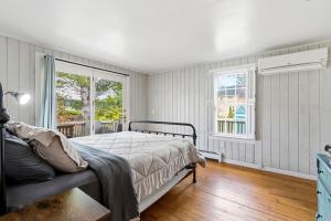 a bedroom with a bed and a window at Charming Kennebunk Cape - Walk to Dock Square! in Kennebunk