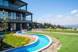a house with a swimming pool in front of a building at Lale Saray Sapanca in Sapanca