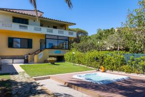 a house with a swimming pool in the yard at B&b Giglio di Mare in Cala Liberotto