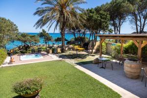 a backyard with a swimming pool and a gazebo at B&b Giglio di Mare in Cala Liberotto +106 photos