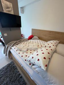 a bedroom with a bed with a tv on the wall at Studio Claudia in Opatija +17 photos
