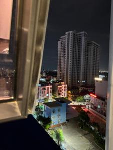 a view from a window of a city at night at 7Homestays in Ðông Khê