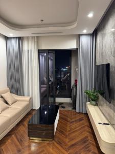 a living room with a couch and a tv at 7Homestays in Ðông Khê