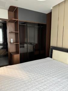 a bedroom with a bed and a large closet at 7Homestays in Ðông Khê