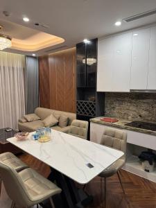 a kitchen and living room with a white table and chairs at 7Homestays in Ðông Khê