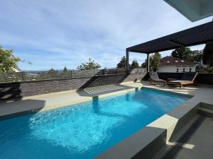 a large blue swimming pool on top of a house at Studio Claudia in Opatija