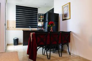 a table with a red table cloth on it in a room at VIP Home in El Aouina Station