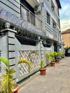 a building with potted plants on the side of it at RÉSIDENCE IDM-Ngoma in Kinshasa