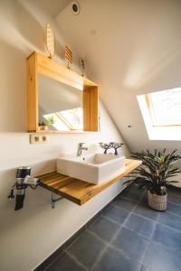 a bathroom with a sink and a mirror at Private spa - La Sparenthèse in Ciney +31 photos