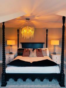 a bedroom with a large bed with a chandelier at Penthouse 333a in Middlesbrough