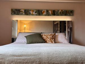 a bedroom with a large bed with a white bedspread at La Casetta di Borgo Appartamento Albero in Lajatico