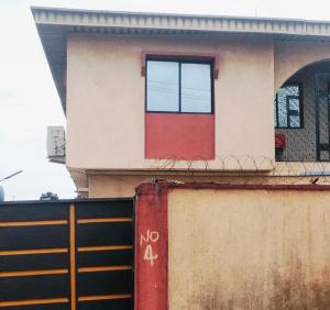 a house with a red door on top of a wall at Avapartmentrentals in Okunola