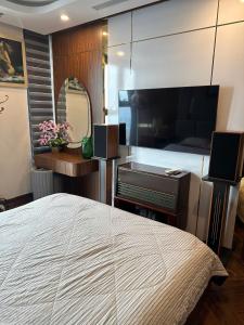 a bedroom with a large bed and a large flat screen tv at 7Homestay in Hai Phong +41 photos