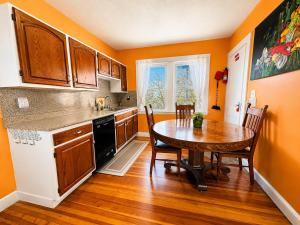 a kitchen with a wooden table and a wooden floor at Victorian Condo in Boston